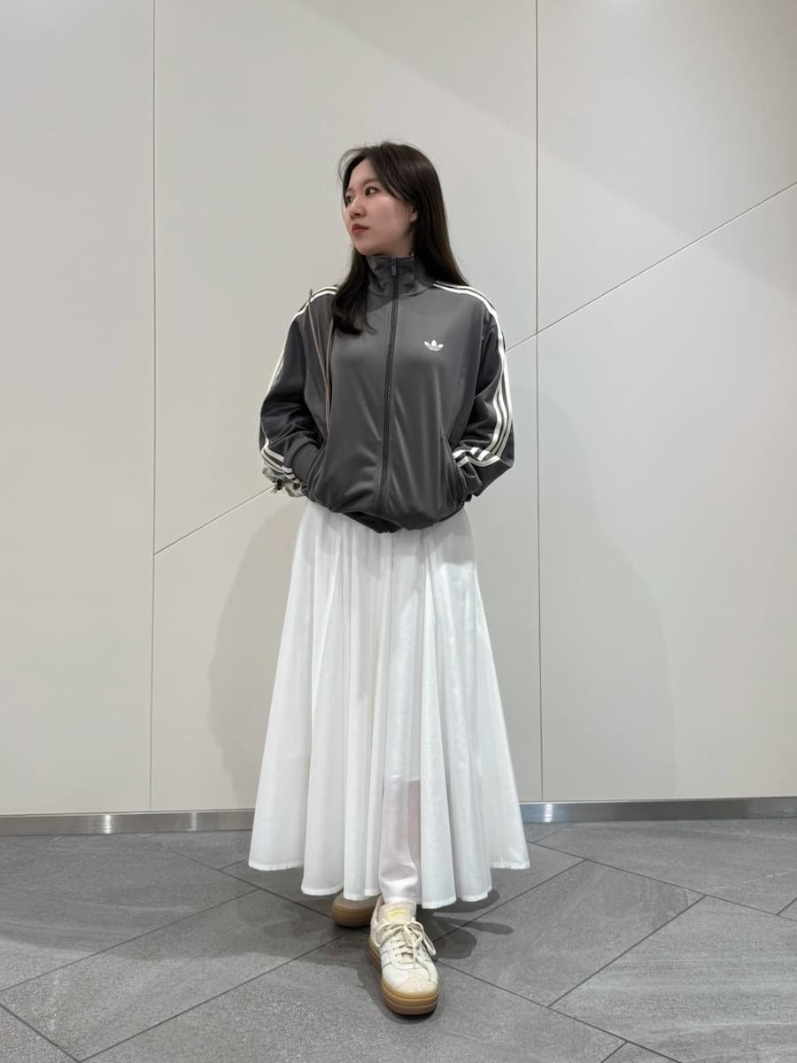 ピンク系のバックパック/リュック、その他のスニーカー、ホワイト系のワンピースを着用したレディースの冬コーディネートの2枚目の写真
