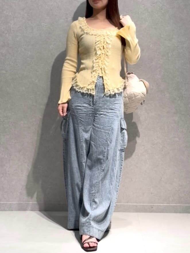 ブルー系のその他パンツ、イエロー系のニット/セーター、ホワイト系のバックパック/リュックを着用したレディースの夏コーディネートの2枚目の写真