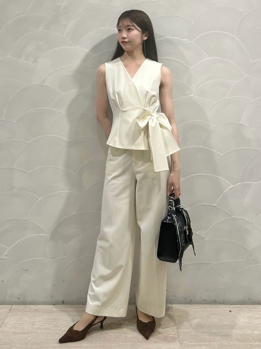 ホワイト系のテーラードジャケット、ホワイト系のスラックス、ブラウン系のパンプスを着用したレディースの冬コーディネートの4枚目の写真