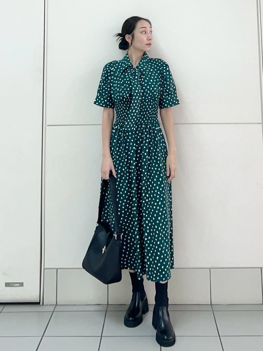 グリーン系のワンピース、ブラック系のトートバッグを着用したレディースの夏コーディネートの2枚目の写真