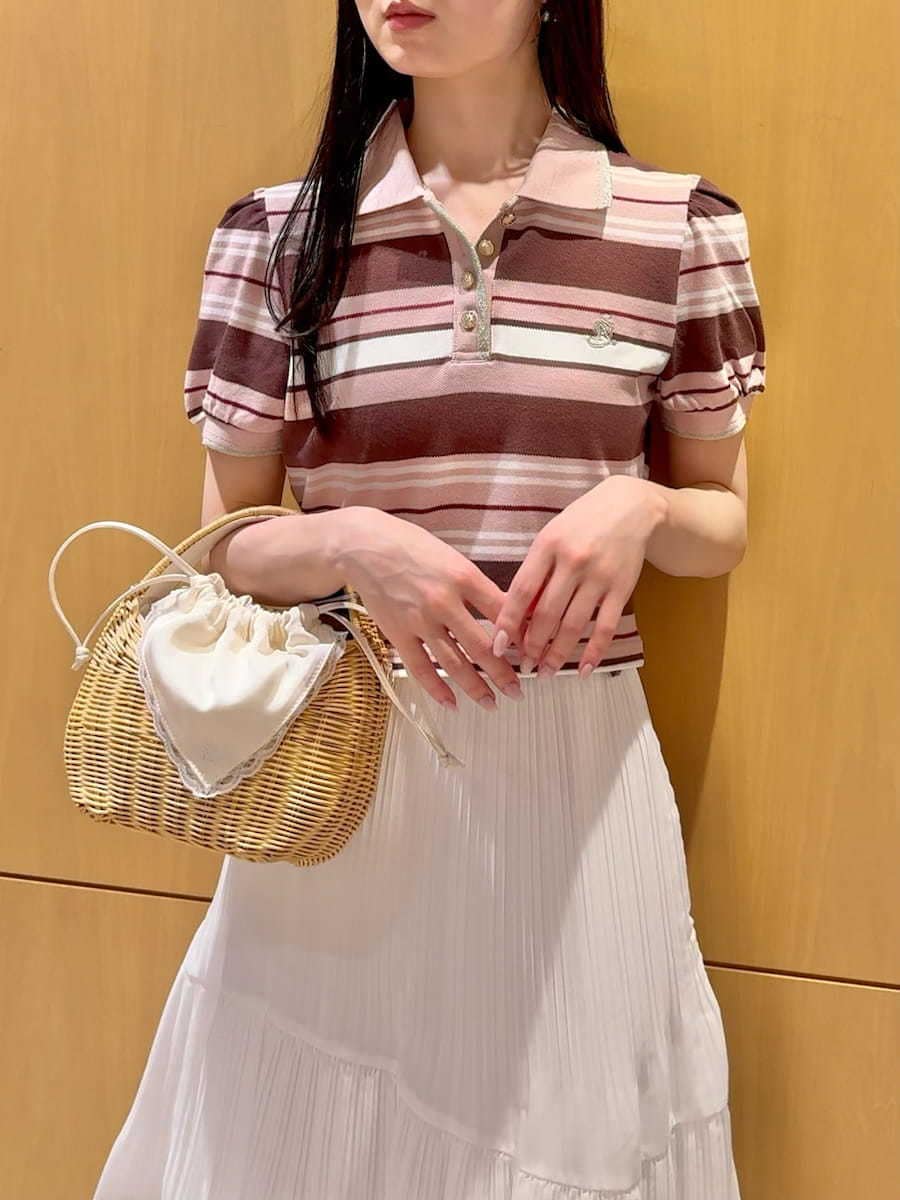 ブラウン系のサンダル、ホワイト系のかごバッグ、ホワイト系のスカートを着用したレディースの春コーディネートの6枚目の写真