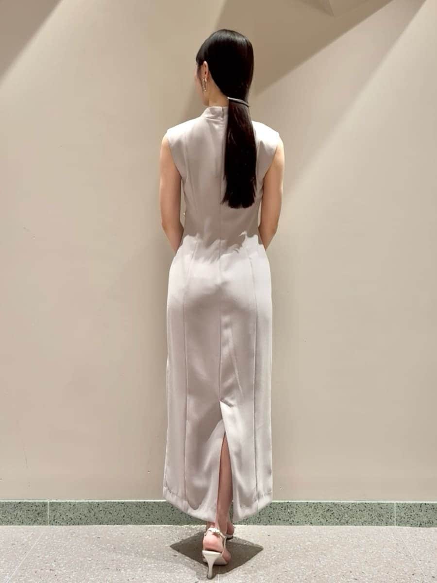 ベージュ系のワンピース、ホワイト系のサンダル、ホワイト系のハンドバッグを着用したレディースの夏コーディネートの3枚目の写真