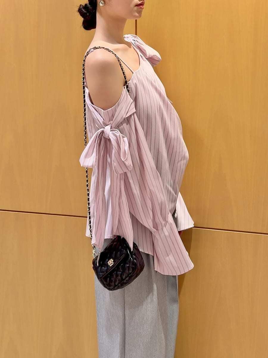 ブラック系のショルダーバッグ、グレー系のその他パンツ、シルバー系のピアス（両耳用）を着用したレディースの冬コーディネートの7枚目の写真