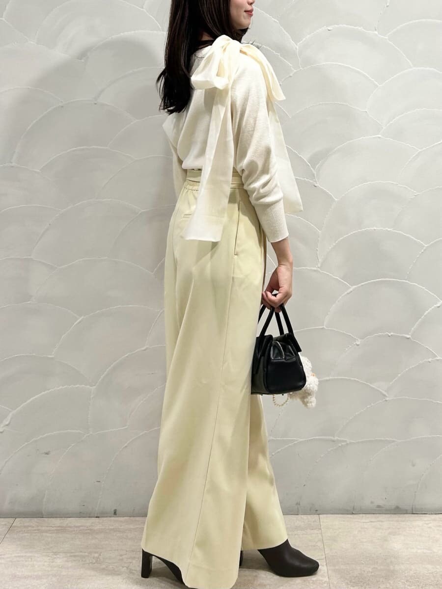 レッド系のブーツ、ホワイト系のニット/セーター、ブラック系のボストンバッグを着用したレディースの秋コーディネートの3枚目の写真