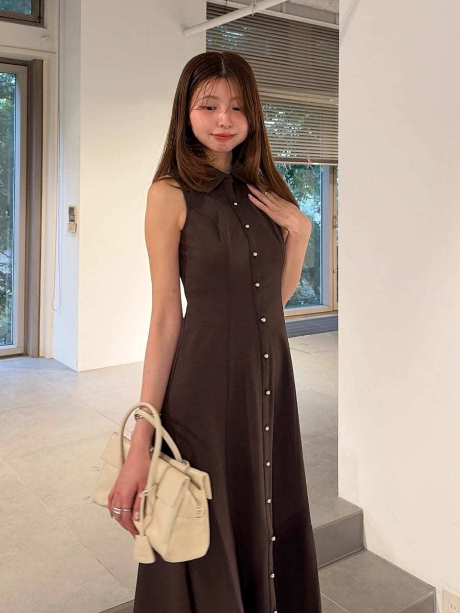 ホワイト系のボストンバッグ、ブラウン系のワンピース、その他のパンプスを着用したレディースの夏コーディネートの2枚目の写真