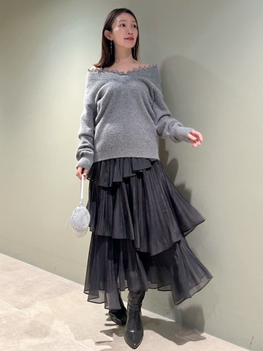 グレー系のブーツ、グレー系のニット/セーター、グレー系のスカートを着用したレディースの冬コーディネートの4枚目の写真