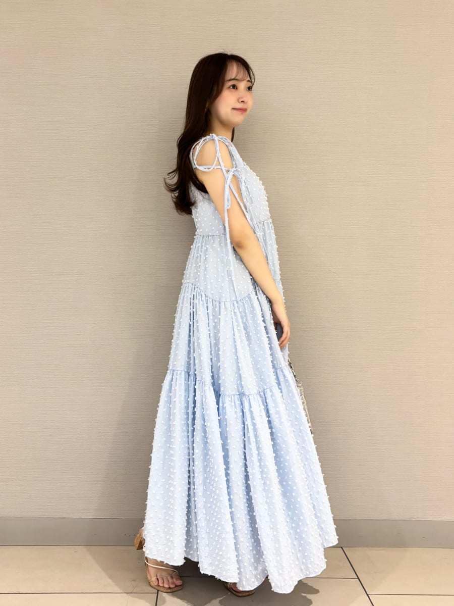 ブルー系のワンピース、シルバー系のショルダーバッグ、その他のサンダルを着用したレディースの夏コーディネートの2枚目の写真