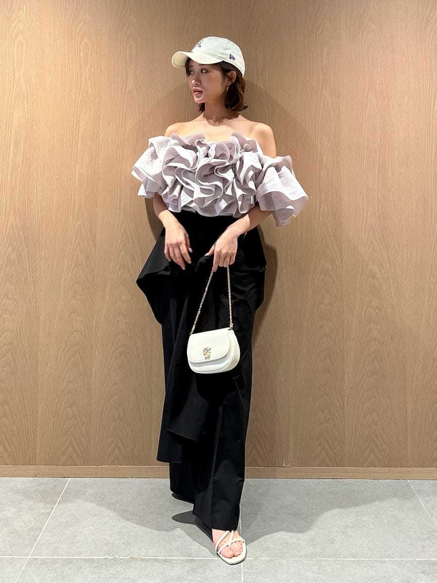 ブラック系のその他パンツ、グレー系のシャツ/ブラウス、ホワイト系のショルダーバッグを着用したレディースの春コーディネートの2枚目の写真