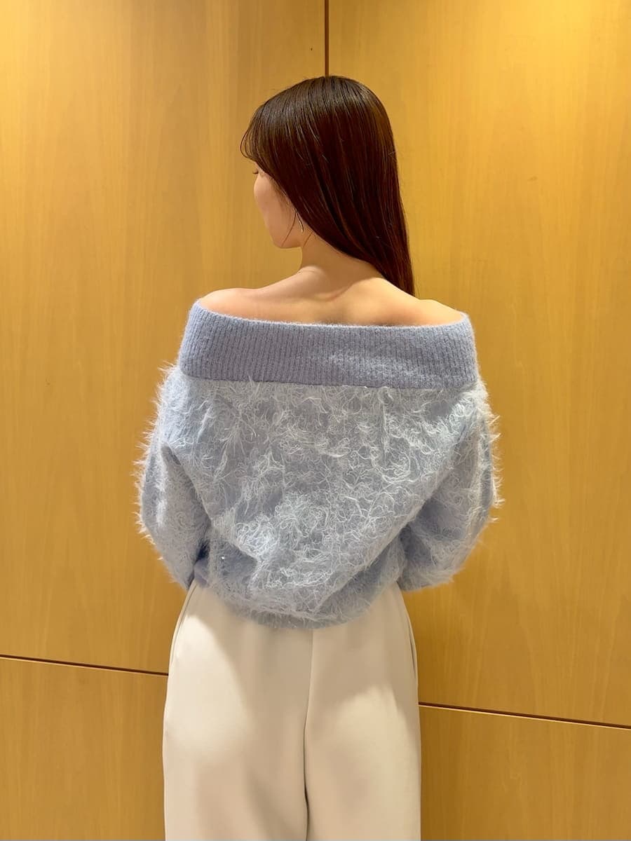 ブラック系のショルダーバッグ、ホワイト系のスウェットパンツ、ブルー系のニット/セーターを着用したレディースの冬コーディネートの5枚目の写真