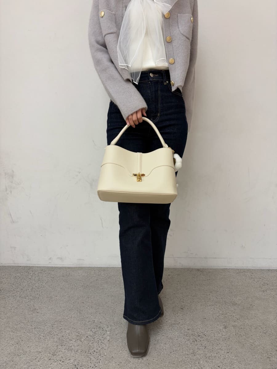 グレー系のノーカラージャケット、ホワイト系のニット/セーター、ブルー系のその他パンツを着用したレディースの冬コーディネートの6枚目の写真