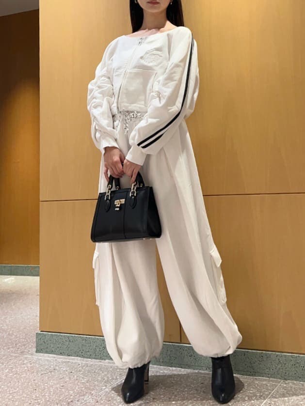 ホワイト系のスウェットパンツ、ホワイト系のスウェット、ブラック系のハンドバッグを着用したレディースの冬コーディネートの4枚目の写真