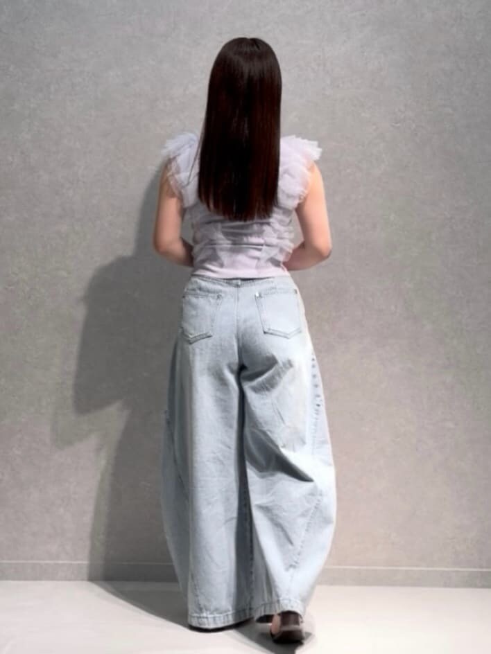 ブラウン系のハンドバッグ、ブルー系のデニムパンツ、パープル系のニット/セーターを着用したレディースの夏コーディネートの4枚目の写真