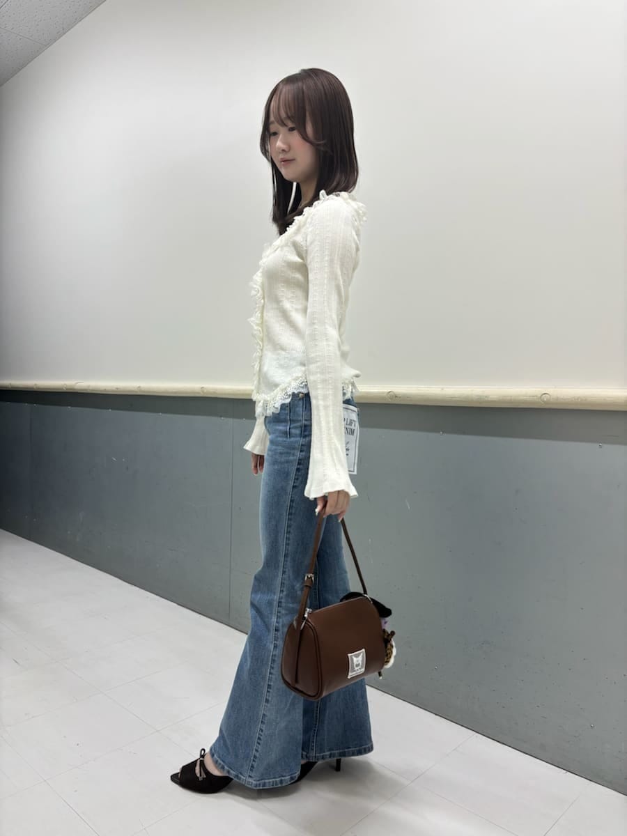 ホワイト系のニット/セーター、ブラウン系のサンダル、ブルー系のデニムパンツを着用したレディースの夏コーディネートの4枚目の写真