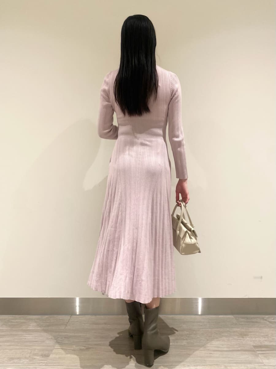 ブラウン系のチェスターコート、ピンク系のワンピース、ホワイト系のボストンバッグを着用したレディースの秋コーディネートの6枚目の写真