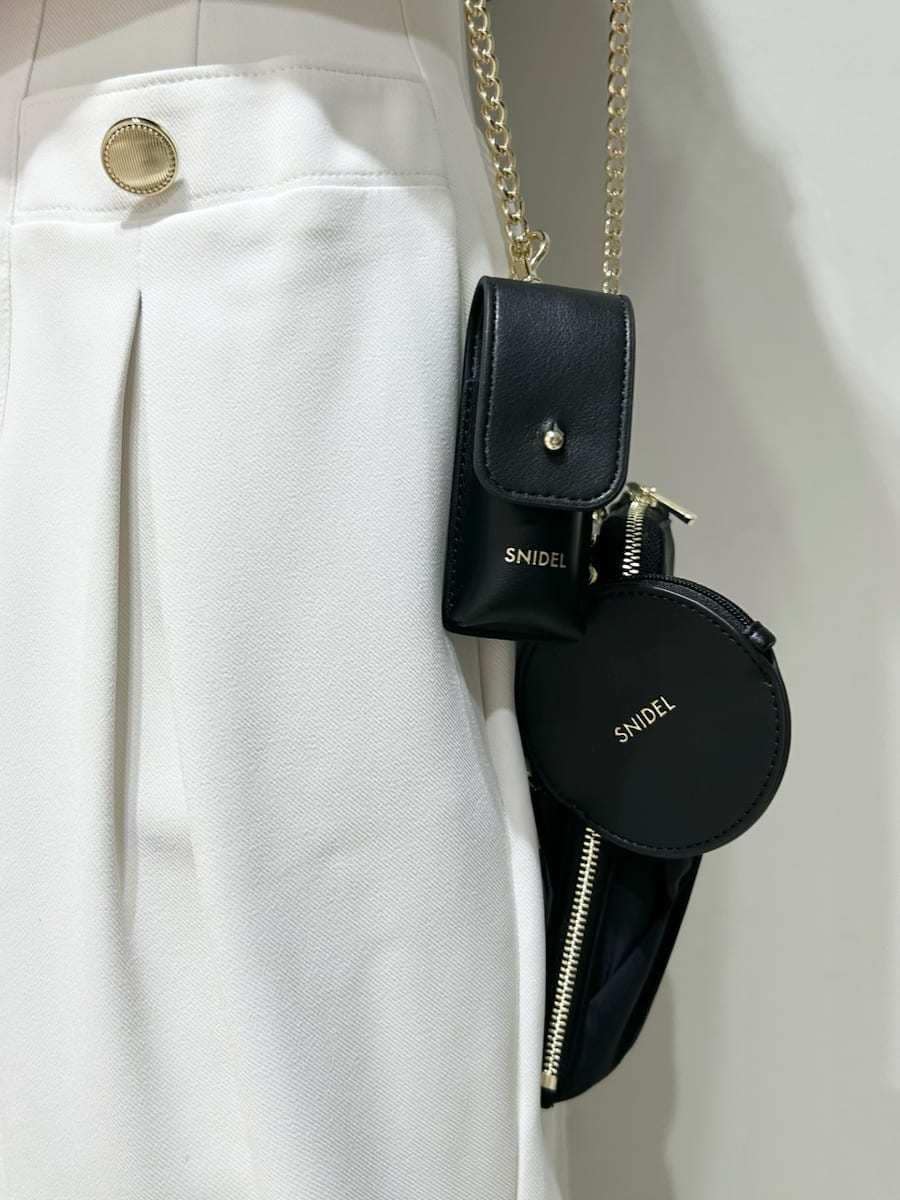 ホワイト系のその他パンツ、ブラック系のニット/セーター、ブラック系のパンプスを着用したレディースの春コーディネートの5枚目の写真