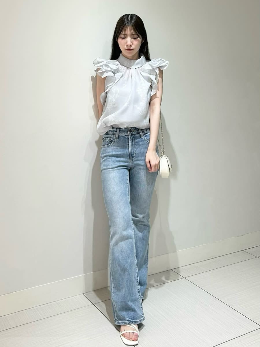 ブルー系のデニムパンツ、ホワイト系のショルダーバッグ、グレー系のシャツ/ブラウスを着用したレディースの春コーディネートの4枚目の写真