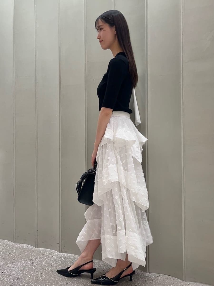 その他のスカート、ブラック系のパンプス、ブラック系のハンドバッグを着用したレディースの春コーディネートの4枚目の写真