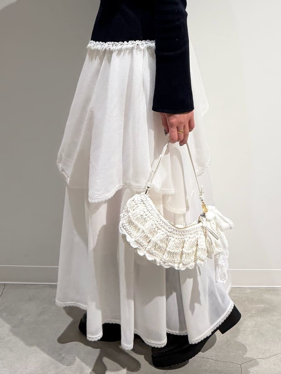 ブラック系のブーツ、ホワイト系のスカート、ブルー系のニット/セーターを着用したレディースの冬コーディネートの9枚目の写真