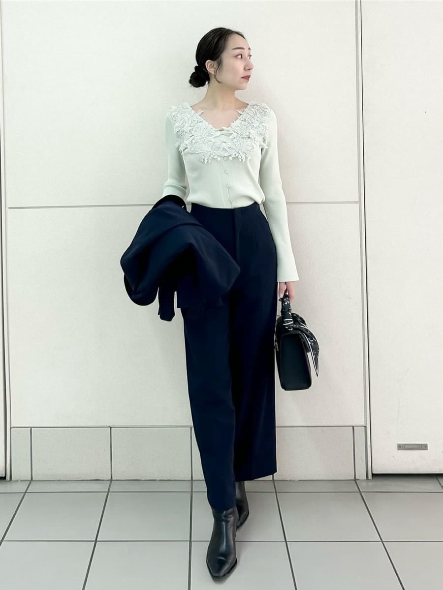 ブルー系のテーラードジャケット、ブルー系のスラックス、ブラック系のハンドバッグを着用したレディースの冬コーディネートの2枚目の写真