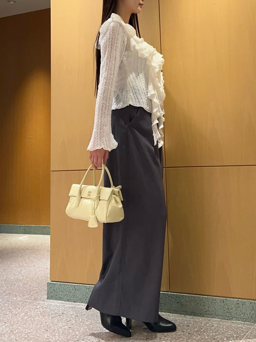 ホワイト系のニット/セーター、イエロー系のボストンバッグを着用したレディースの冬コーディネートの3枚目の写真