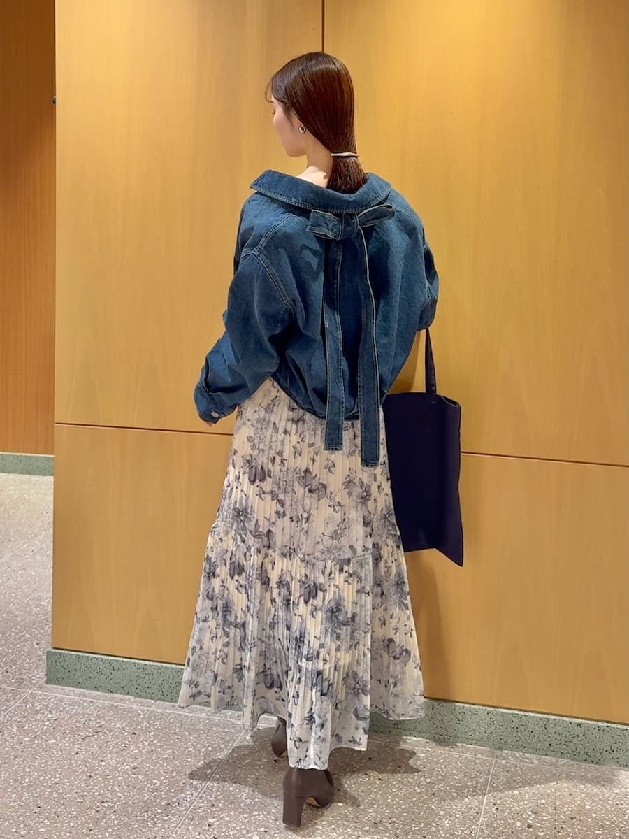 ブルー系のブルゾン、イエロー系のワンピース、ブルー系のトートバッグを着用したレディースの冬コーディネートの2枚目の写真