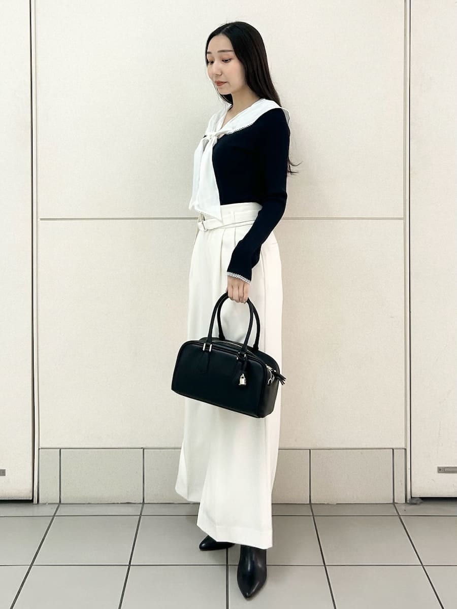 ブラック系のブーツ、ブルー系のニット/セーター、ホワイト系のその他パンツを着用したレディースの冬コーディネートの3枚目の写真