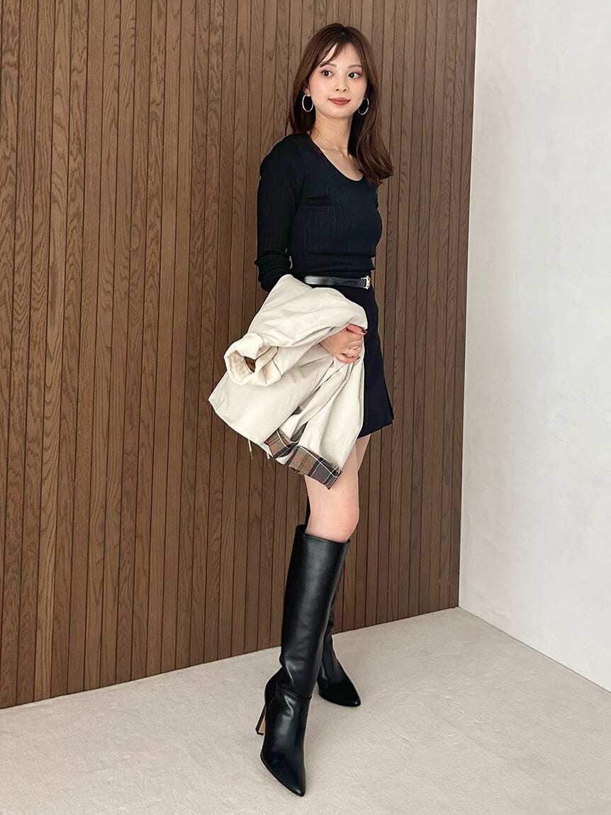 ホワイト系のブルゾン、ブラック系のスカート、ブラック系のブーツを着用したレディースの秋コーディネートの3枚目の写真