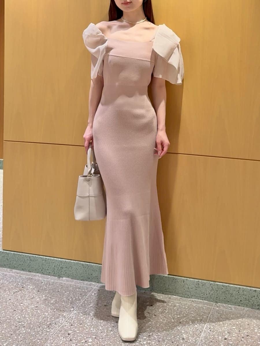 ピンク系のワンピース、ベージュ系のハンドバッグ、ホワイト系のネックレスを着用したレディースの春コーディネートの7枚目の写真