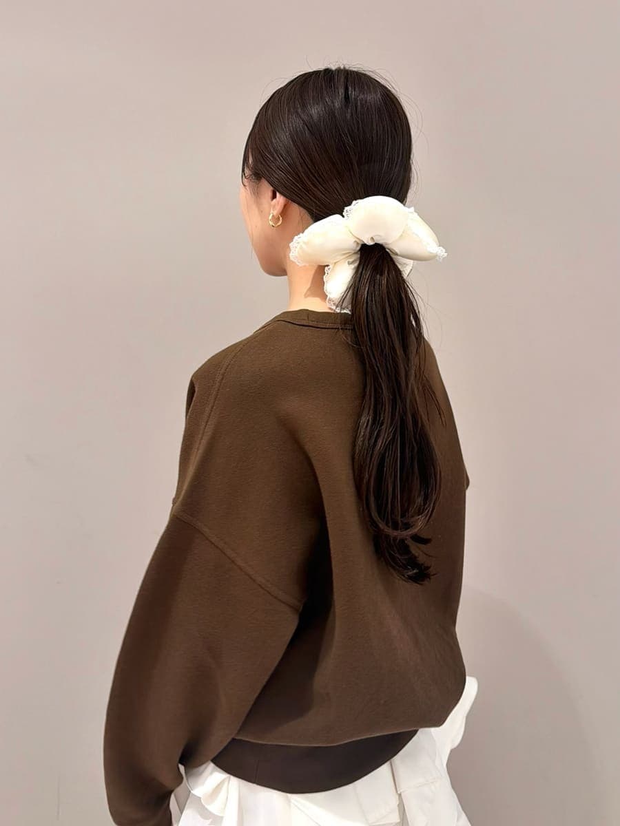 ホワイト系のスカート、ブラウン系のスウェット、イエロー系のボストンバッグを着用したレディースの春コーディネートの6枚目の写真