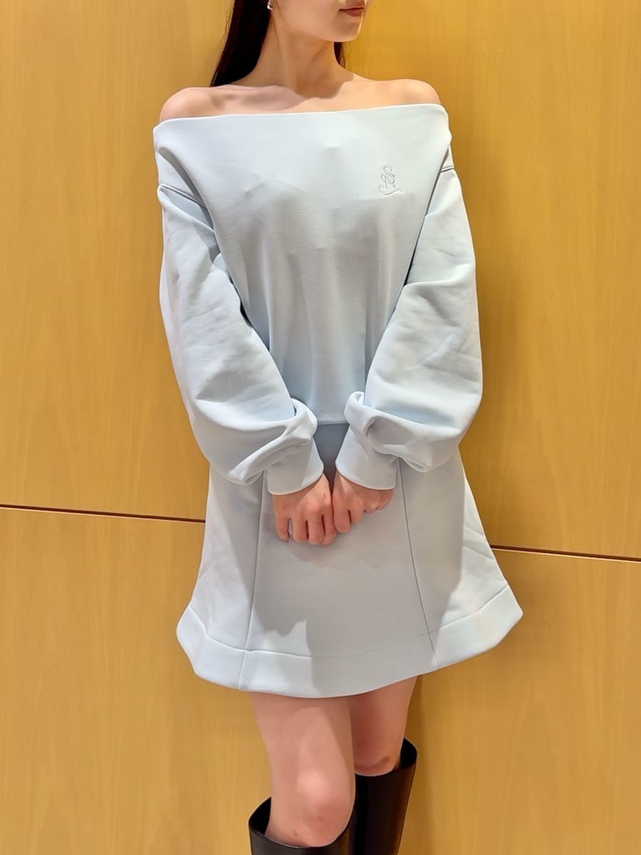 ブラック系のブーツ、ホワイト系のダウンジャケット/コート、ブルー系のワンピースを着用したレディースの冬コーディネートの6枚目の写真