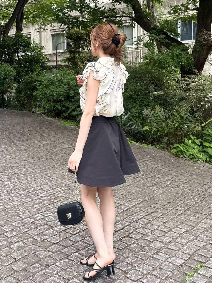 ブラック系のショルダーバッグ、ブラック系のその他パンツ、イエロー系のシャツ/ブラウスを着用したレディースの春コーディネートの4枚目の写真