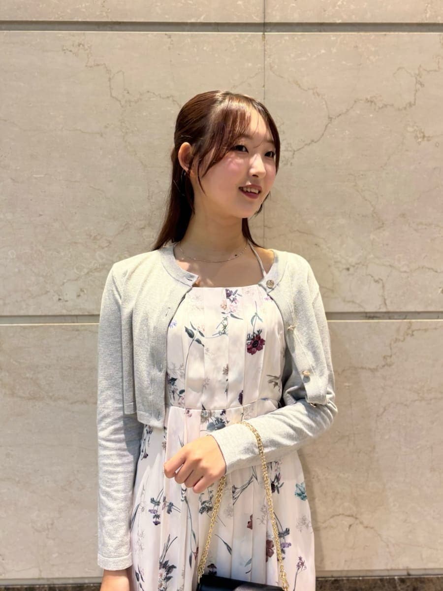 ホワイト系のワンピース、ブラック系のパンプス、ブラック系のショルダーバッグを着用したレディースの冬コーディネートの4枚目の写真