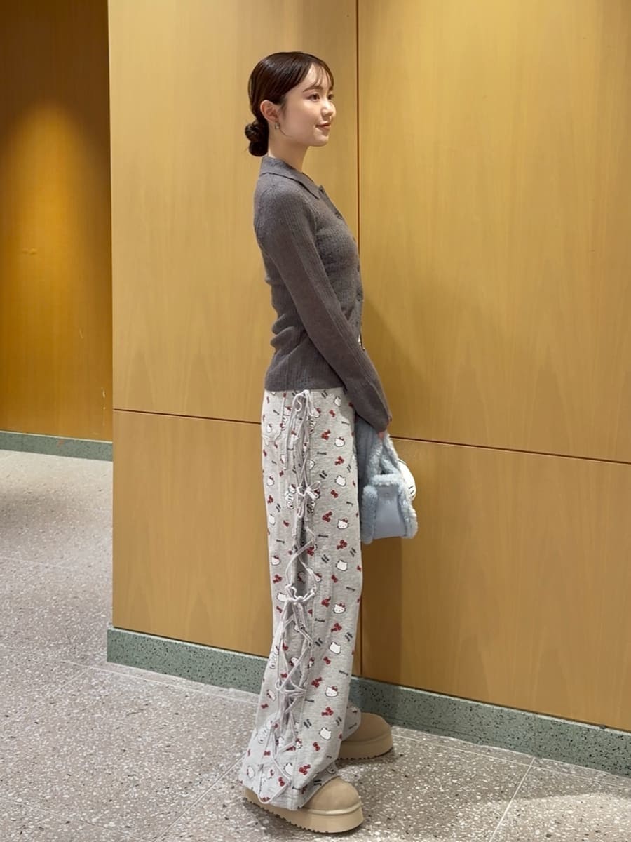 グレー系のニット/セーター、グレー系のその他パンツ、ブルー系のハンドバッグを着用したレディースの秋コーディネートの2枚目の写真