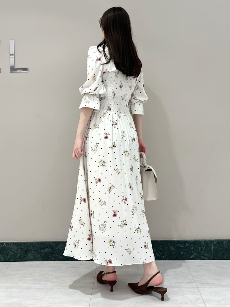 ブラウン系のパンプス、ベージュ系のハンドバッグ、その他のワンピースを着用したレディースの春コーディネートの4枚目の写真