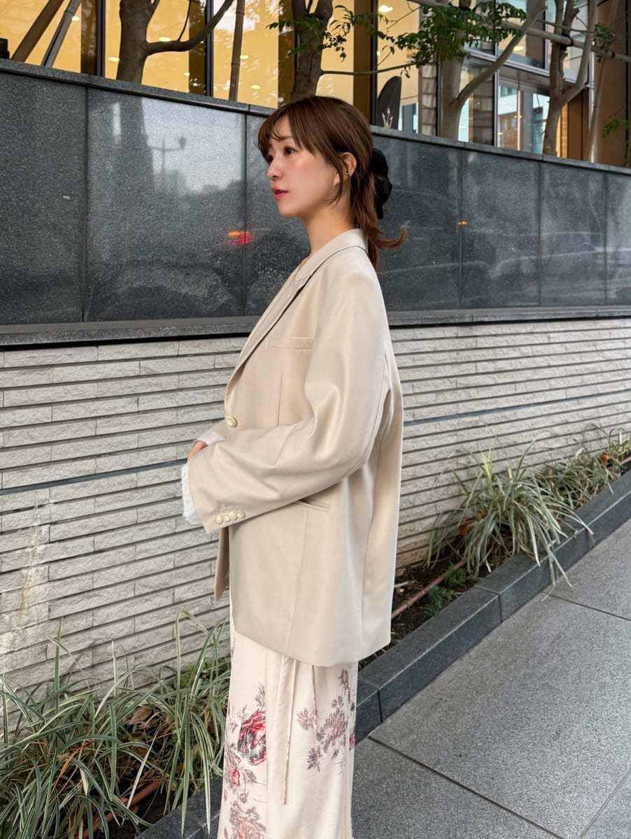 ホワイト系のキャミソール、ベージュ系のテーラードジャケット、ホワイト系のワンピースを着用したレディースの冬コーディネートの4枚目の写真