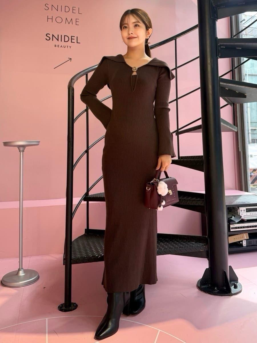 ブラック系のブルゾン、ブラウン系のワンピース、ブラック系のブーツを着用したレディースの秋コーディネートの3枚目の写真