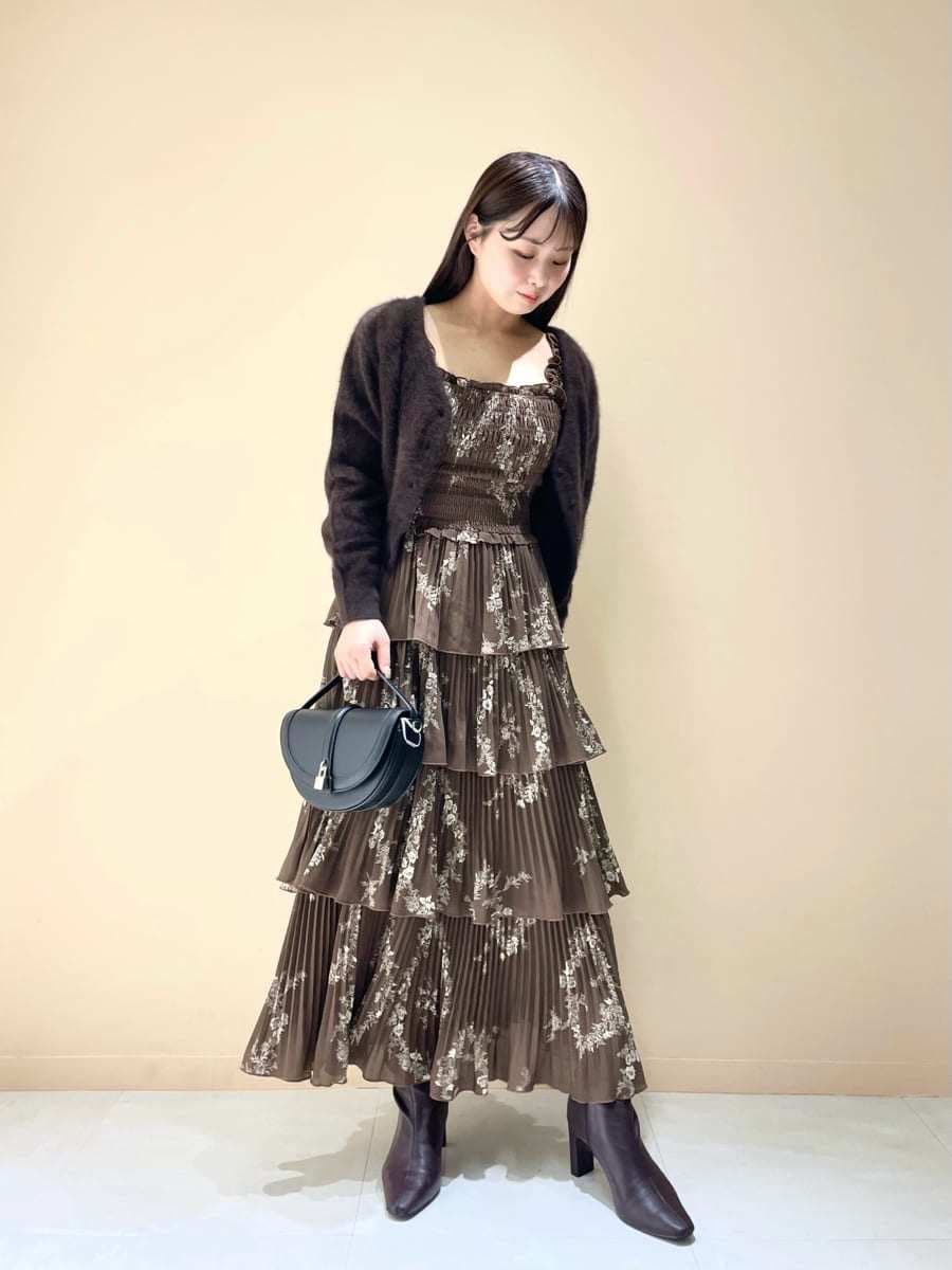 ブラウン系のカーディガン/ボレロ、ブラウン系のワンピース、ブラック系のハンドバッグを着用したレディースの秋コーディネートの2枚目の写真