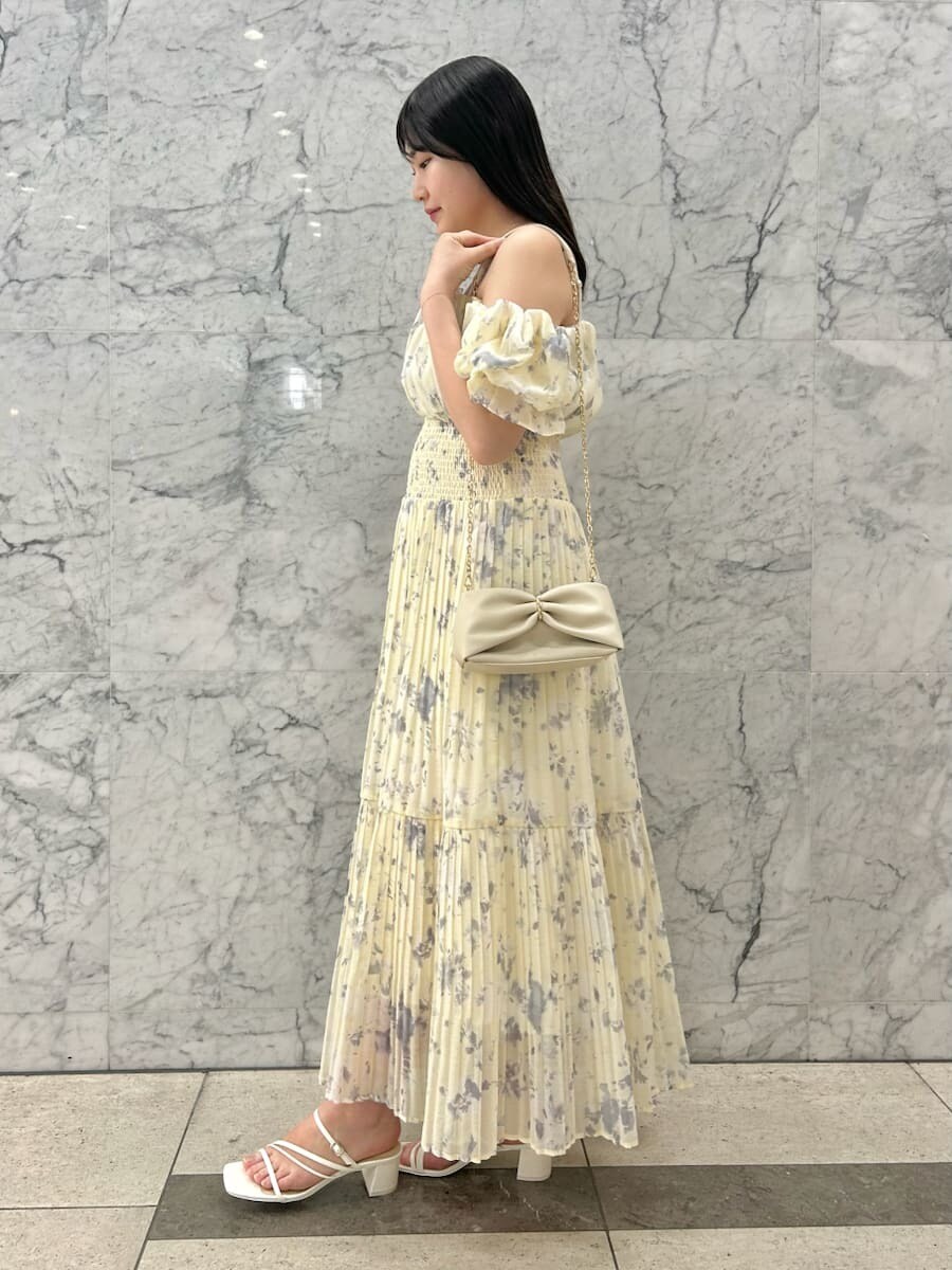 イエロー系のワンピース、ホワイト系のサンダルを着用したレディースの夏コーディネートの2枚目の写真