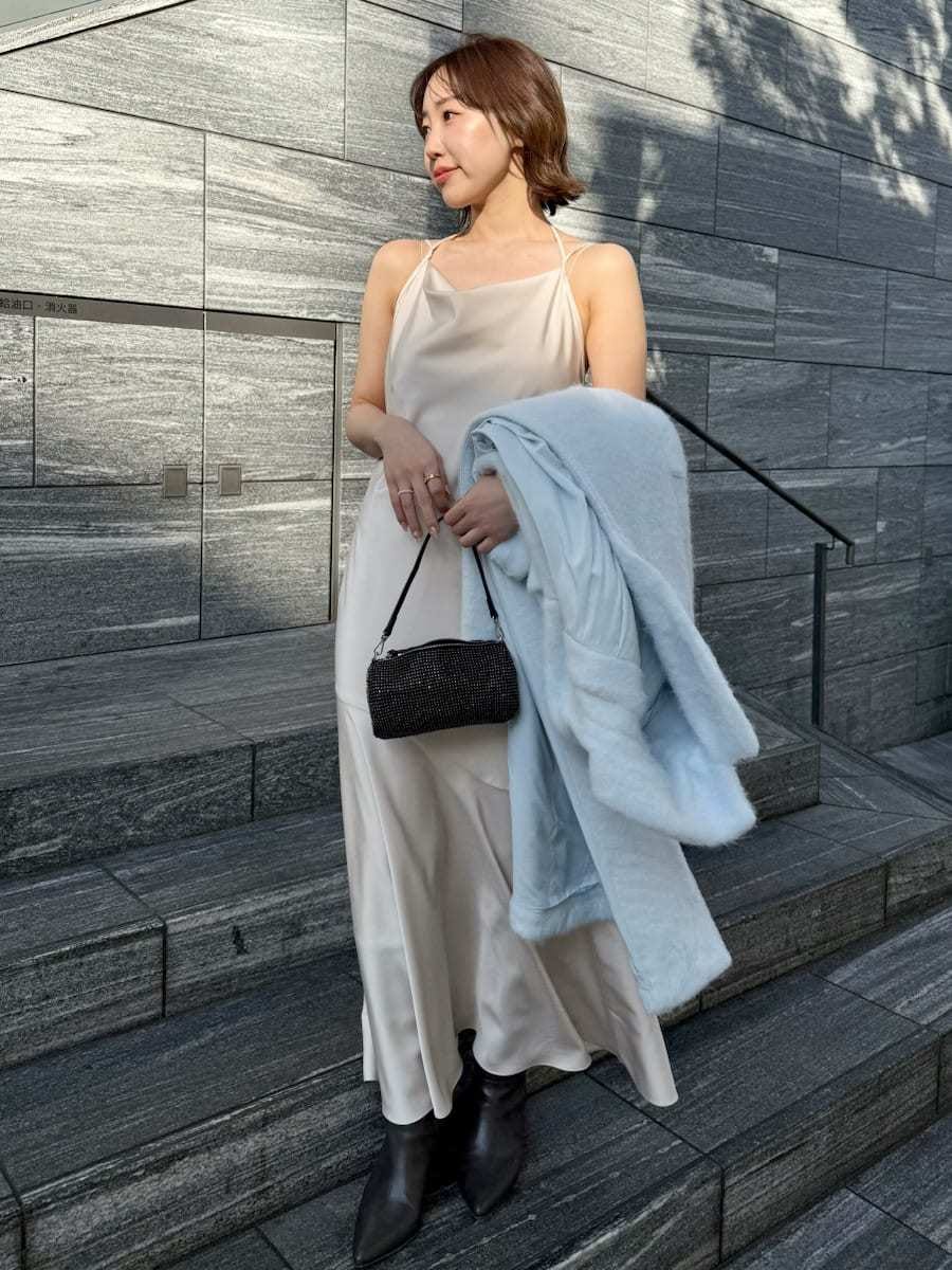 ブルー系のチェスターコート、ホワイト系のワンピースを着用したレディースの冬コーディネートの6枚目の写真