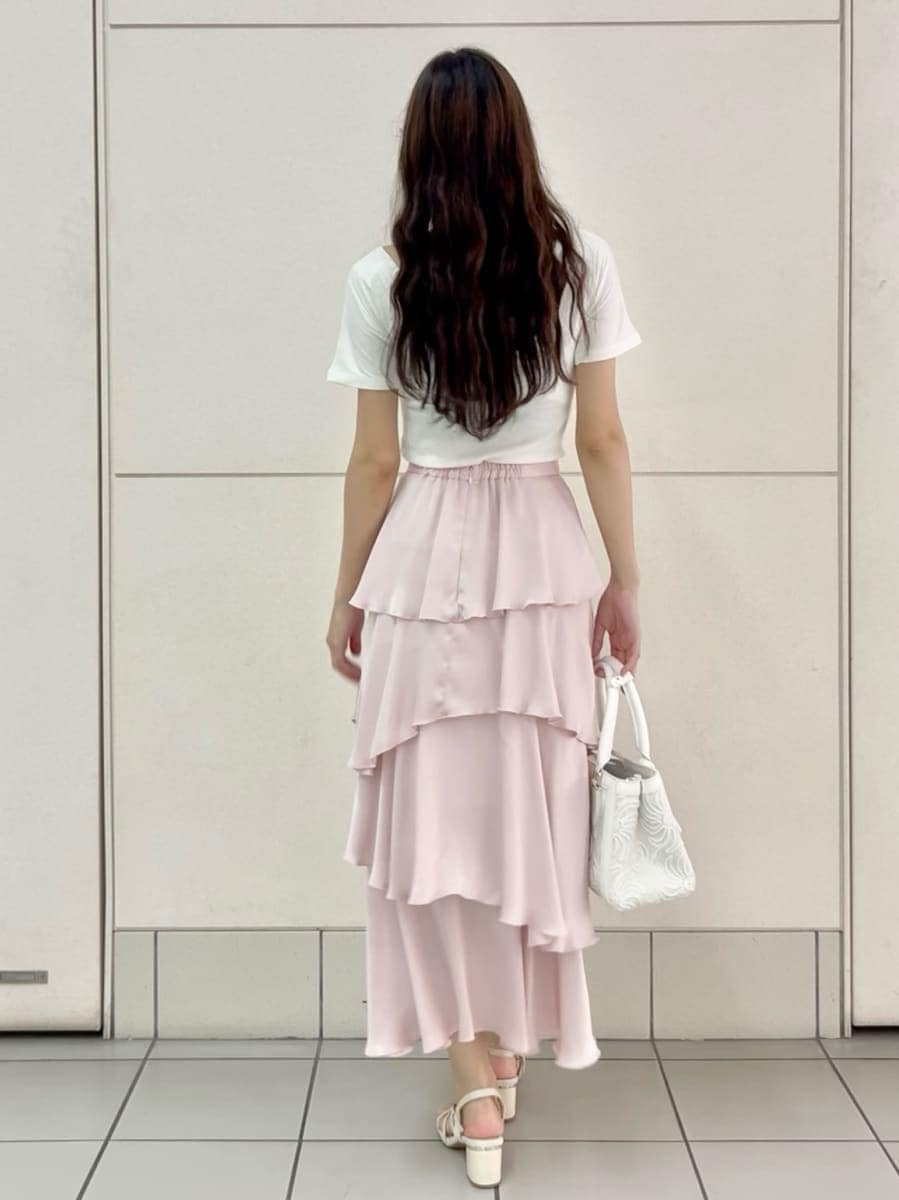 ピンク系のスカート、ホワイト系のTシャツ/カットソー、ホワイト系のハンドバッグを着用したレディースの夏コーディネートの3枚目の写真