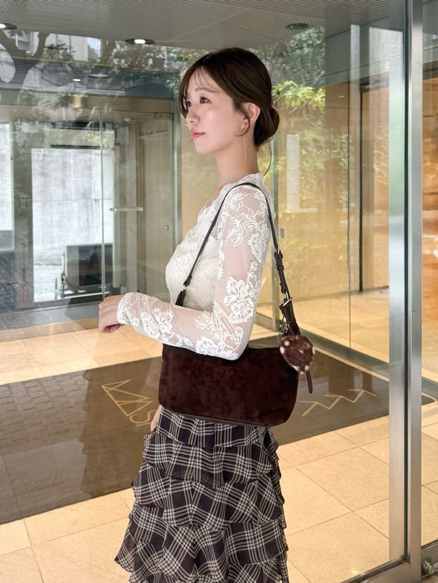 ホワイト系のTシャツ/カットソー、ブラウン系のブーツ、ブラウン系のショルダーバッグを着用したレディースの秋コーディネートの4枚目の写真