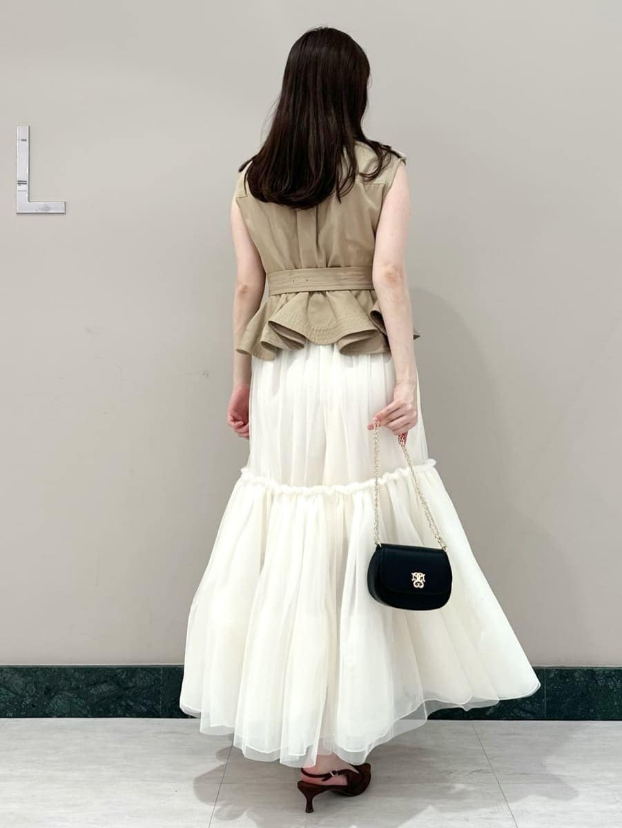 ベージュ系のワンピース、ブラウン系のパンプス、ブラック系のショルダーバッグを着用したレディースの春コーディネートの4枚目の写真