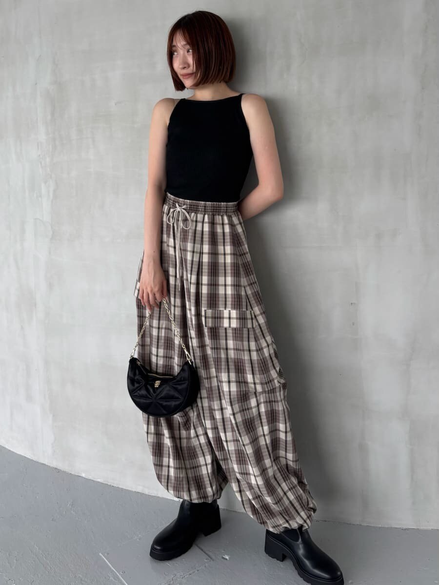 ブラック系のニット/セーター、ベージュ系のその他パンツ、ブラック系のショルダーバッグを着用したレディースの夏コーディネートの4枚目の写真