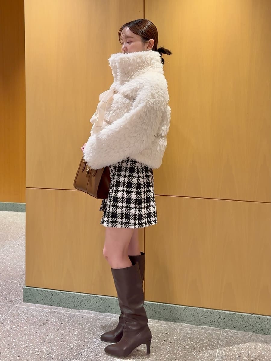 ホワイト系のムートンコート、ブラック系のその他パンツ、ブラック系のニット/セーターを着用したレディースの秋コーディネートの3枚目の写真