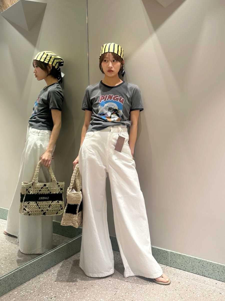 ホワイト系のデニムパンツ、グレー系のTシャツ/カットソー、ブラック系のトートバッグを着用したレディースの夏コーディネートの5枚目の写真