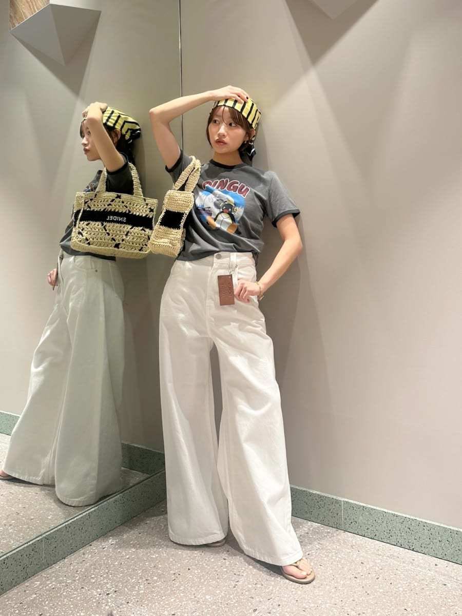 ホワイト系のデニムパンツ、グレー系のTシャツ/カットソー、ブラック系のトートバッグを着用したレディースの夏コーディネートの2枚目の写真
