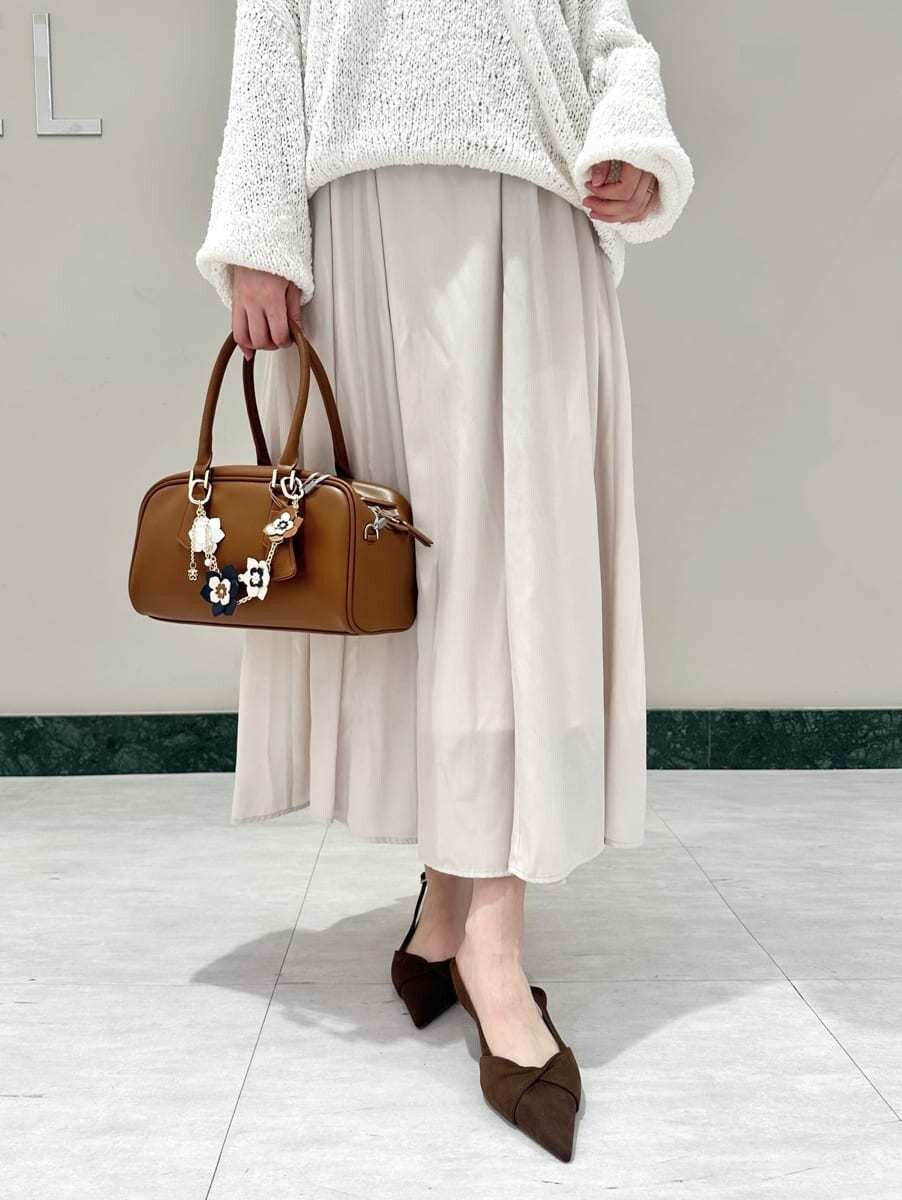 ホワイト系のワンピース、ブラウン系のパンプス、イエロー系のボストンバッグを着用したレディースの春コーディネートの3枚目の写真