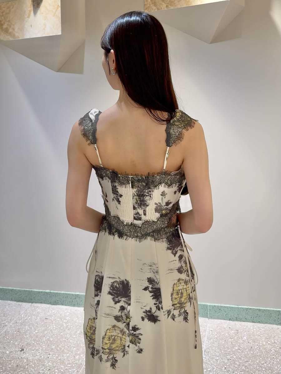 イエロー系のワンピース、ブラック系のショルダーバッグ、シルバー系のピアス（両耳用）を着用したレディースの春コーディネートの5枚目の写真