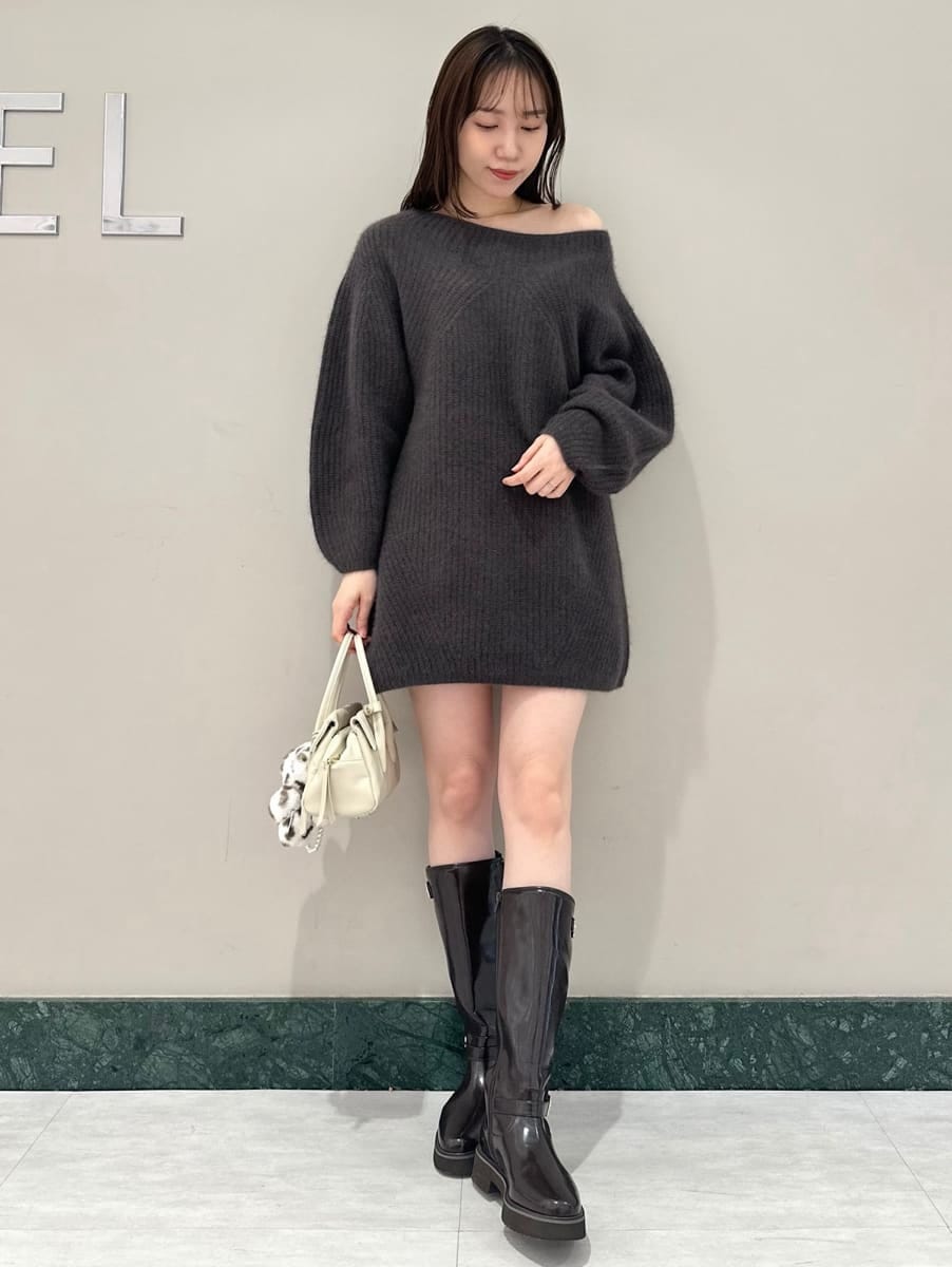 ブラウン系のブーツ、ホワイト系のボストンバッグ、グレー系のワンピースを着用したレディースの秋コーディネートの2枚目の写真