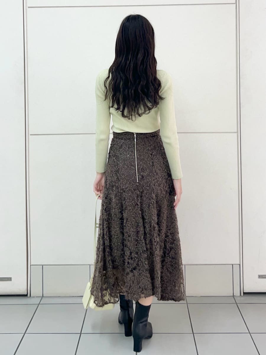 ブラウン系のスカート、イエロー系のニット/セーター、イエロー系のショルダーバッグを着用したレディースの秋コーディネートの3枚目の写真